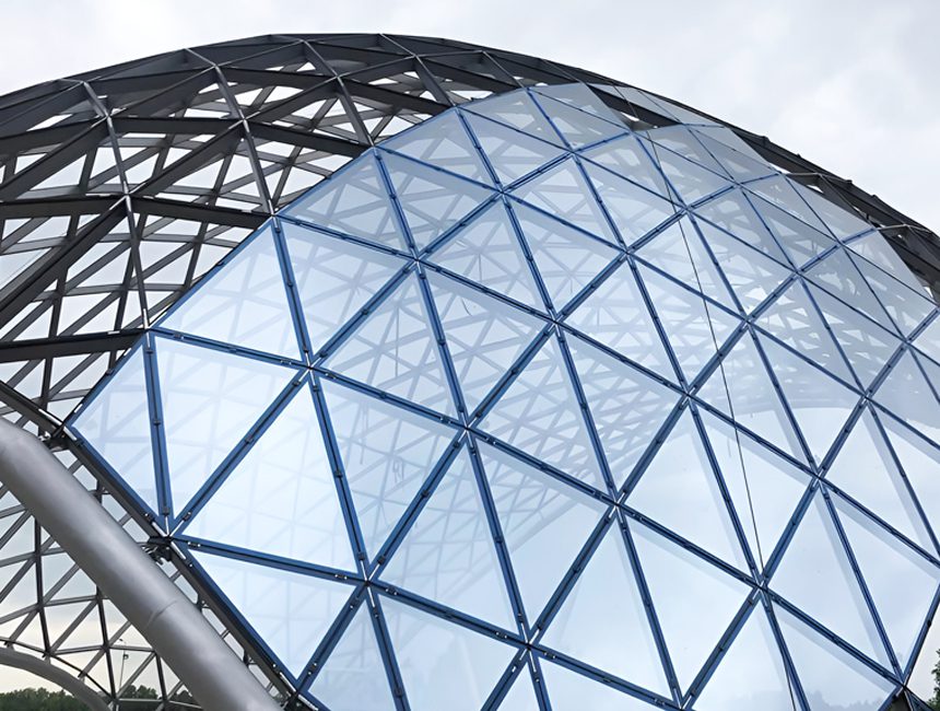 A geometric metal space frame structure supporting a large roof.